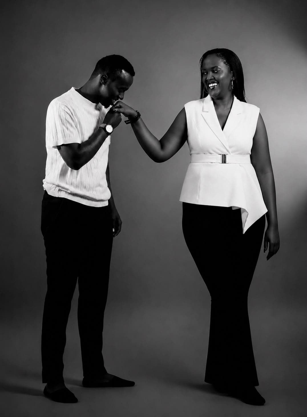 Black and white portrait of Tristan kissing Alisiane's hand