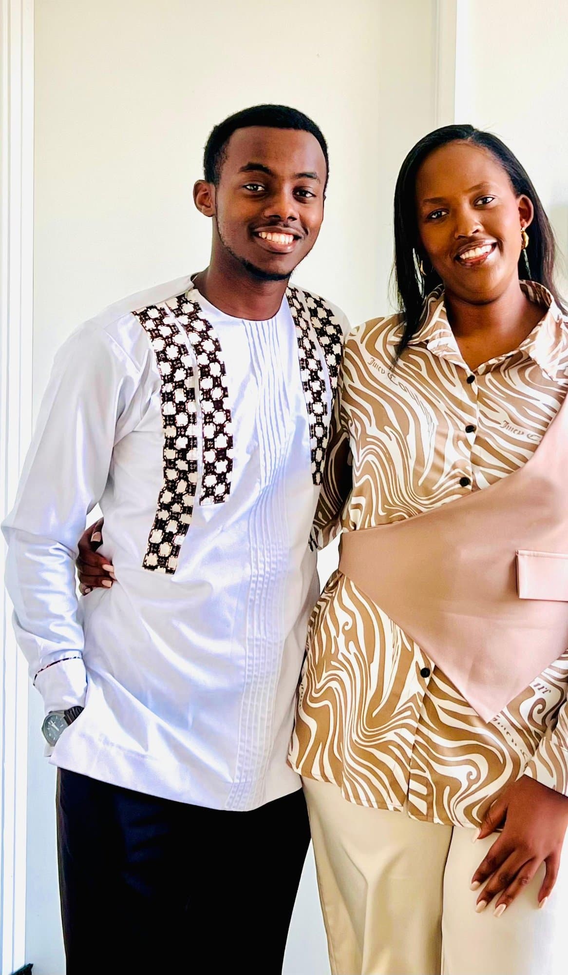 Alisiane and Tristan smiling together in coordinating outfits