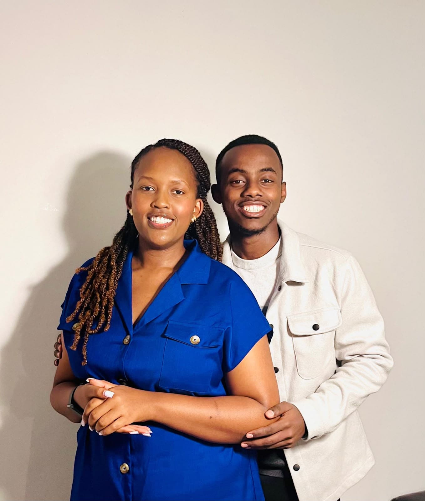Alisiane and Tristan embracing in a candid studio portrait