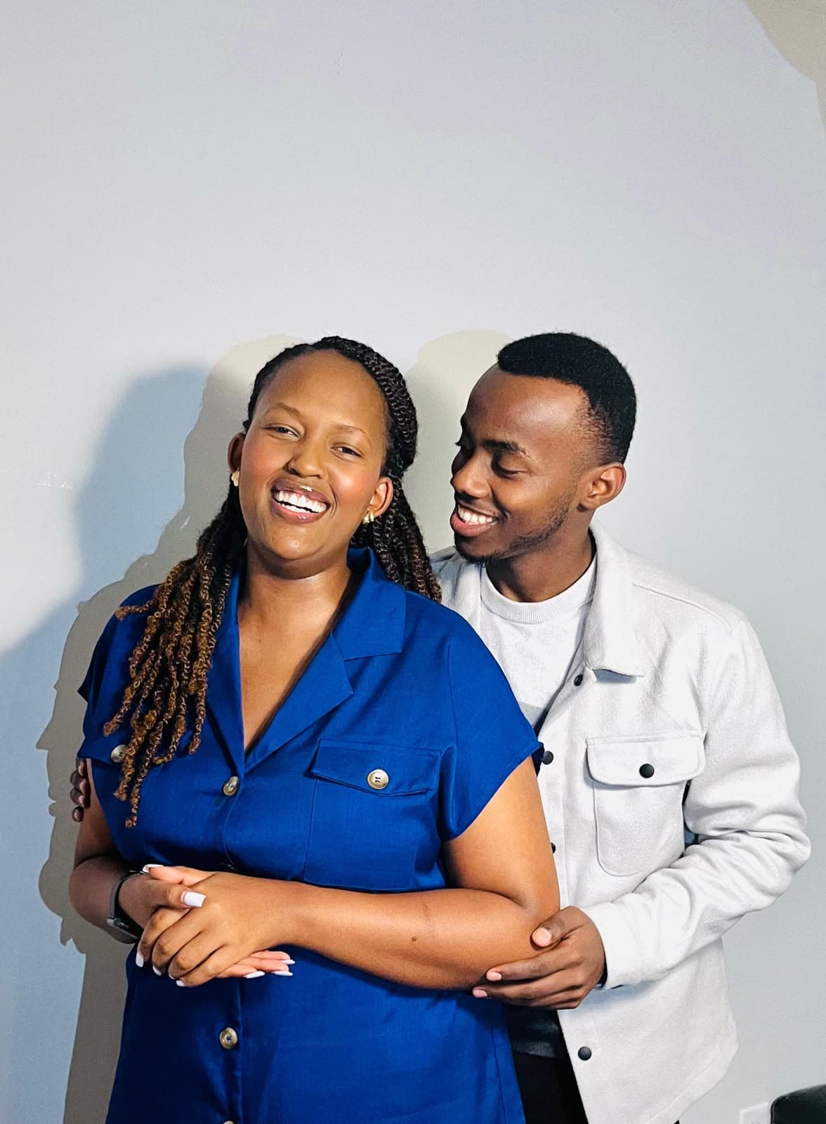 Alisiane laughing with Tristan close behind her in a candid studio portrait